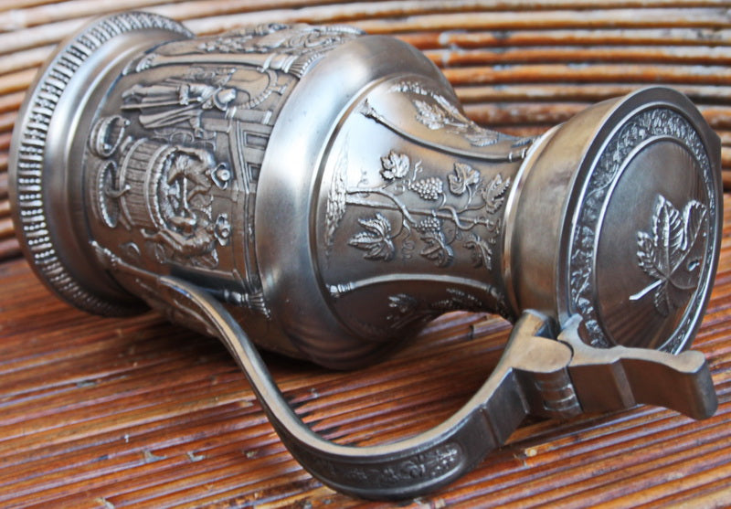 Vintage tin pitcher with bas-reliefs