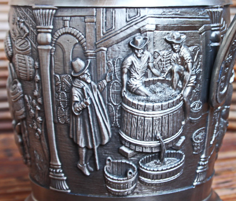 Vintage tin pitcher with bas-reliefs