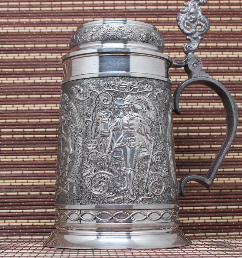 Large vintage pewter mug with bas-reliefs.