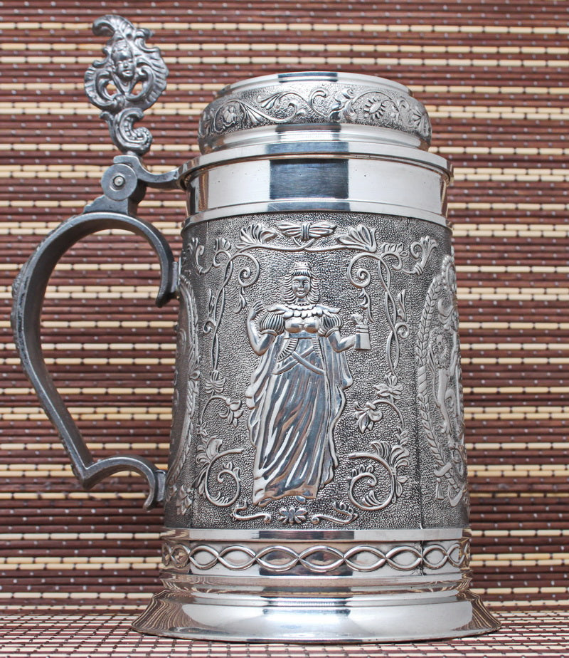 Large vintage pewter mug with bas-reliefs.