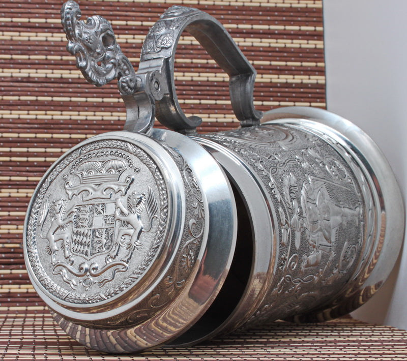 Large vintage pewter mug with bas-reliefs.