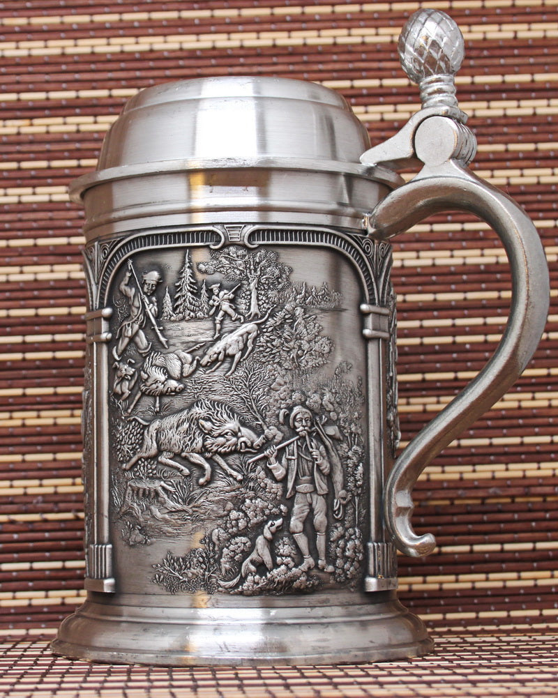 Vintage pewter mug with bas-reliefs. Ancient hunting