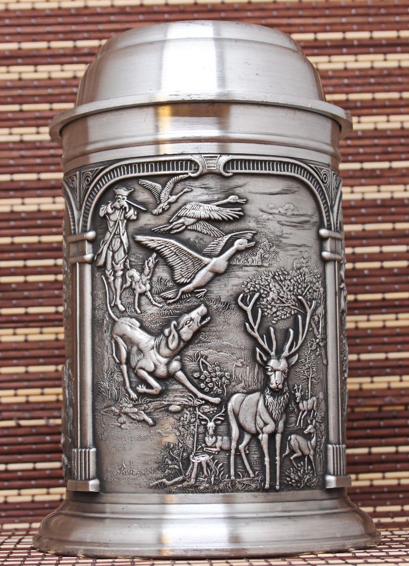 Vintage pewter mug with bas-reliefs. Ancient hunting