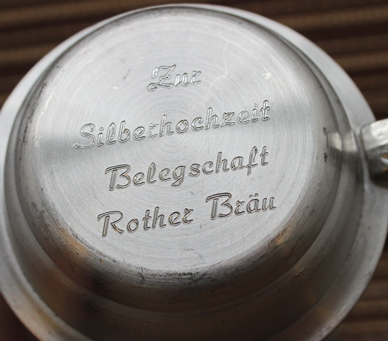 Vintage pewter mug with bas-reliefs. Ancient hunting