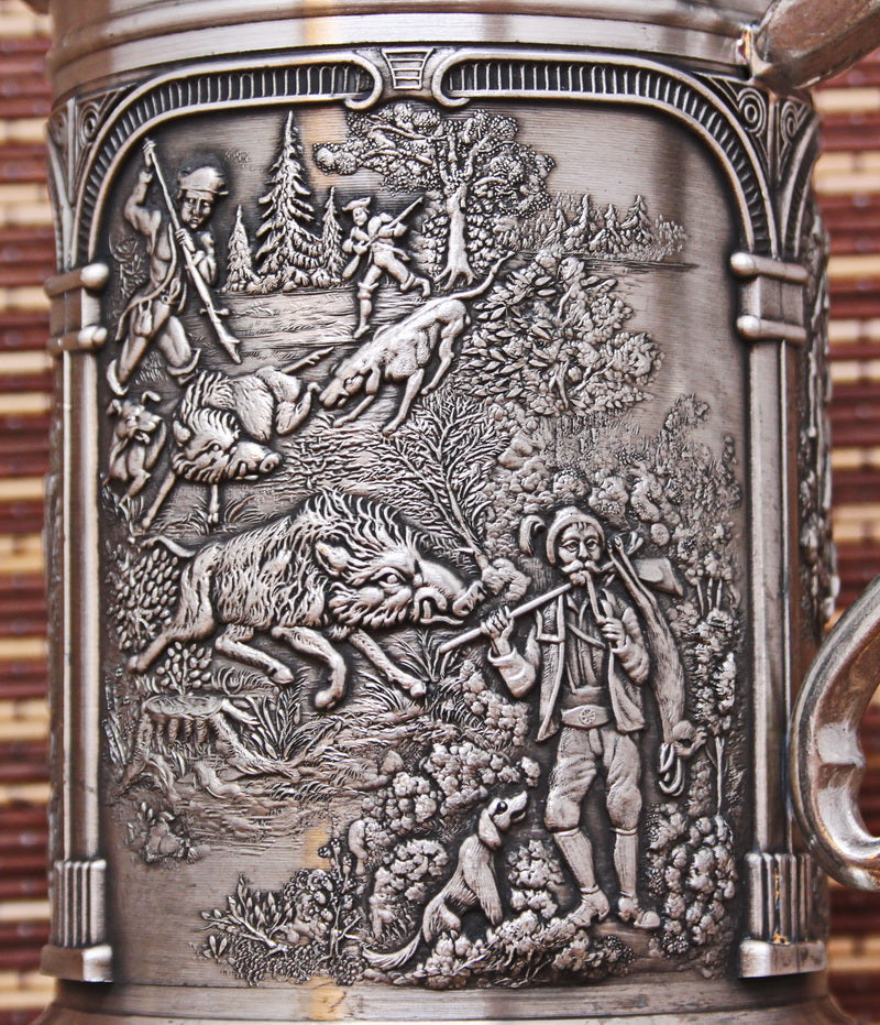 Vintage pewter mug with bas-reliefs. Ancient hunting
