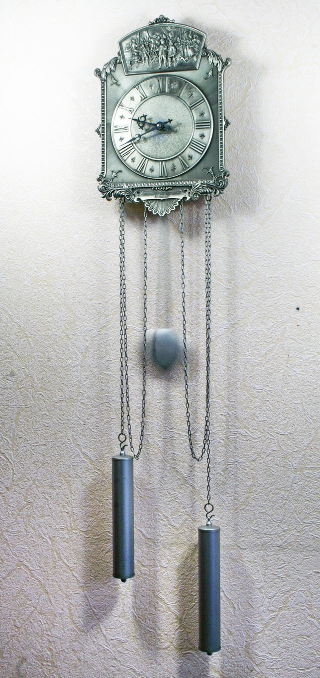 Vintage tin wall clock with pendulum. Reproduction of a painting by Rembrandt.