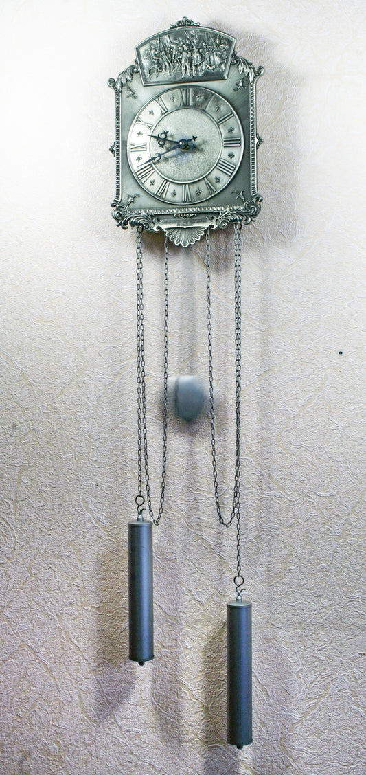 Vintage tin wall clock with pendulum. Reproduction of a painting by Rembrandt.