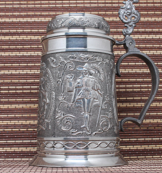 Large vintage pewter mug with bas-reliefs.