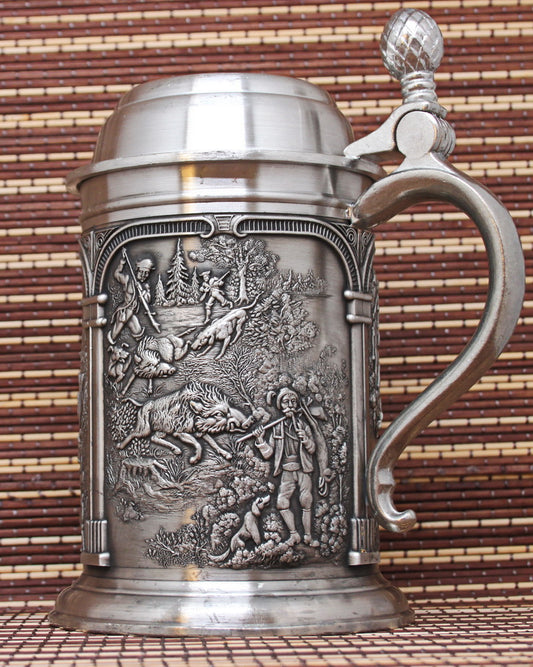 Vintage pewter mug with bas-reliefs. Ancient hunting